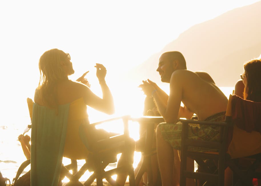 People enjoying a vibrant sunset beach gathering in Naxos, Greece, creating a warm and lively atmosphere